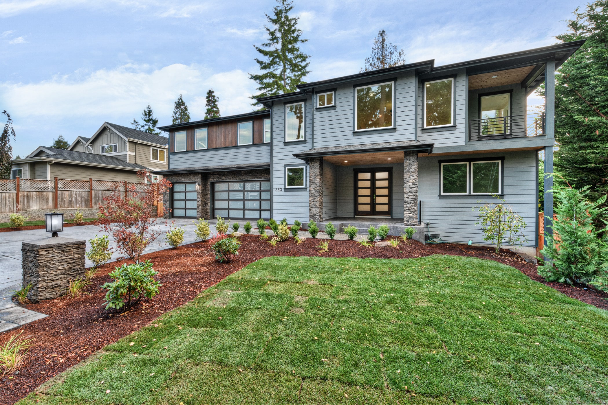 A newly built two-story modern home in Washington with a gray exterior, showcasing the contemporary architectural style by TP Home Builds. 