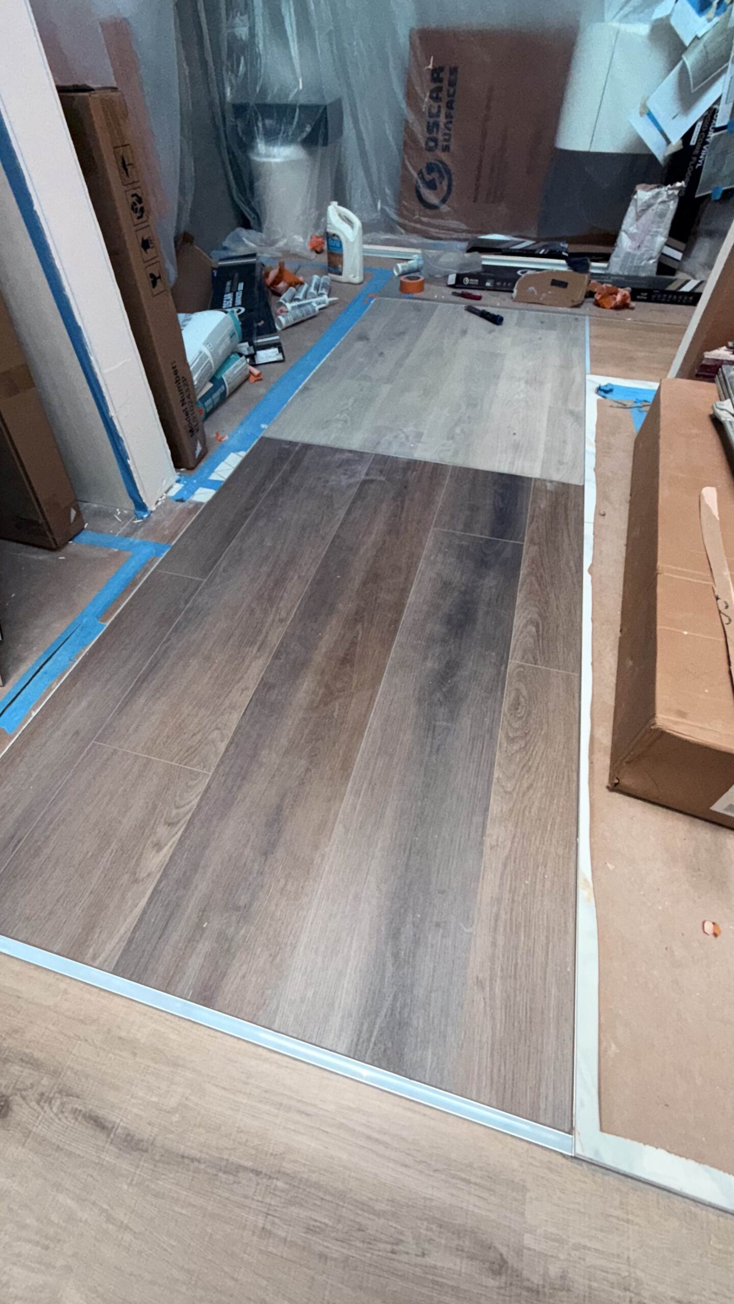 An overhead view of the Oscar Surfaces showroom floor layout, highlighting various tile and surface designs in a modern, stylized setting.
