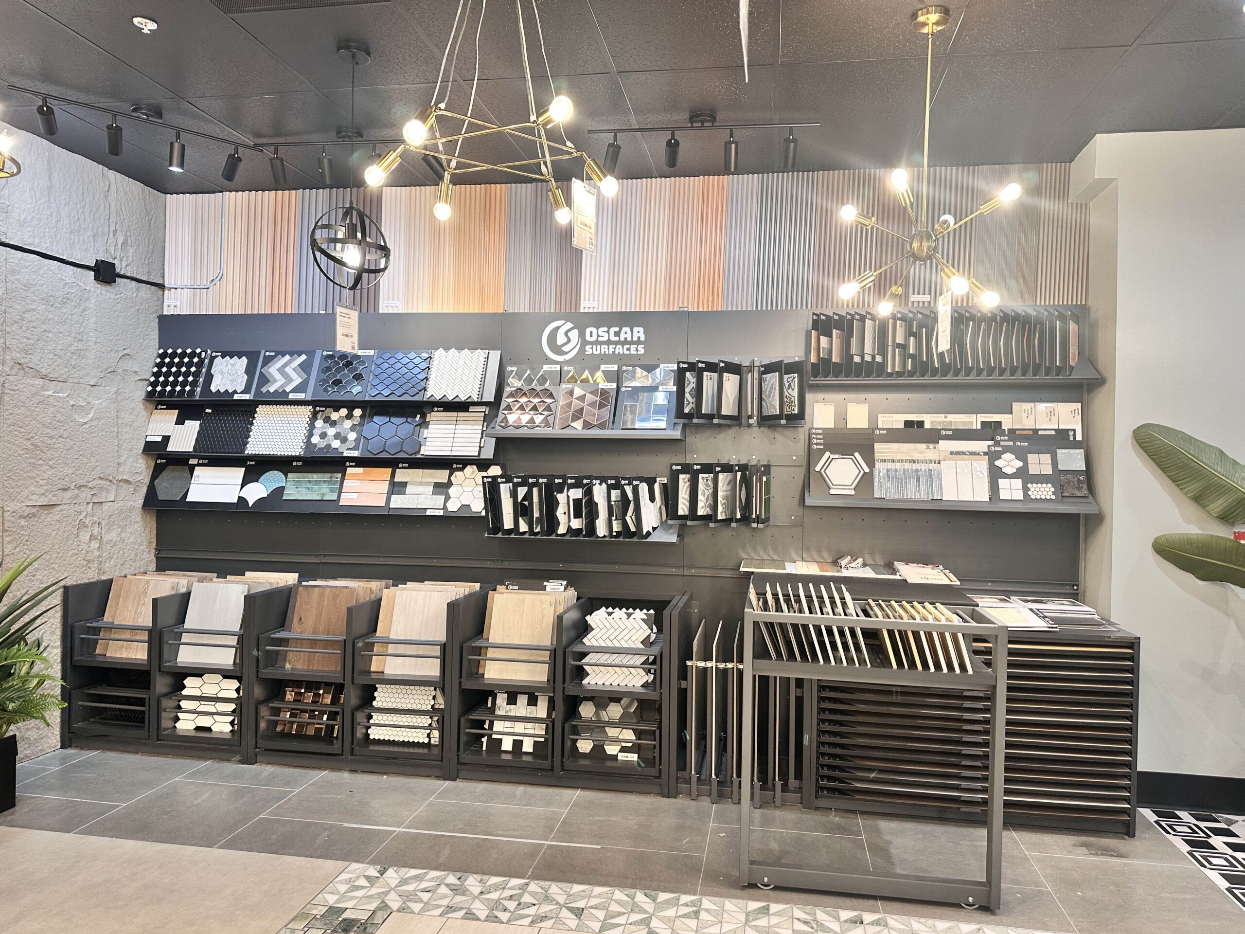 An interior shot of the Oscar Surfaces showroom, featuring a wall display of a wide variety of tile and surface options for customers.