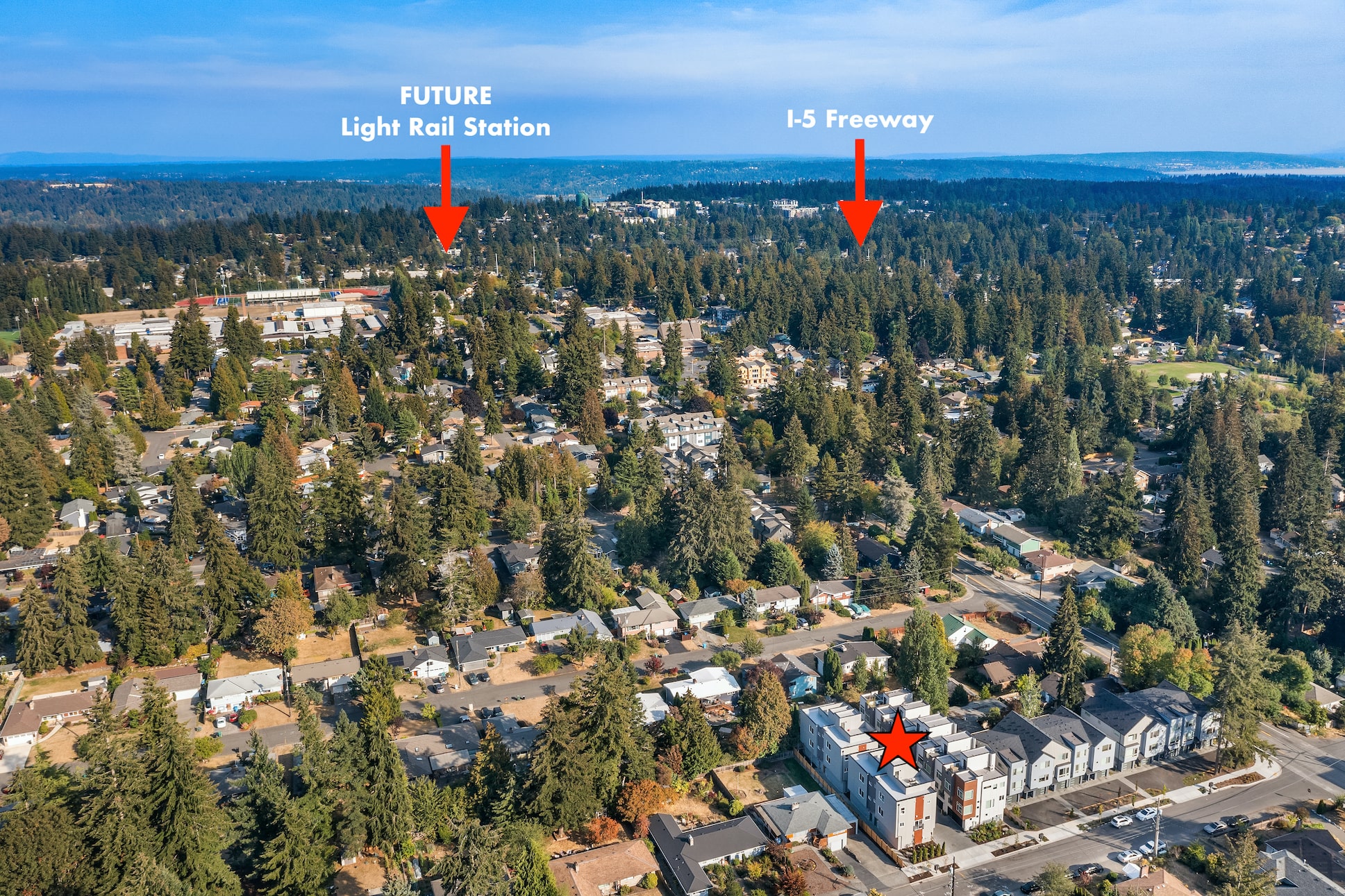 An aerial photo of a residential development in Washington, highlighting its proximity to the future light rail station and I-5 freeway, showing a key selling point for TP Home projects.